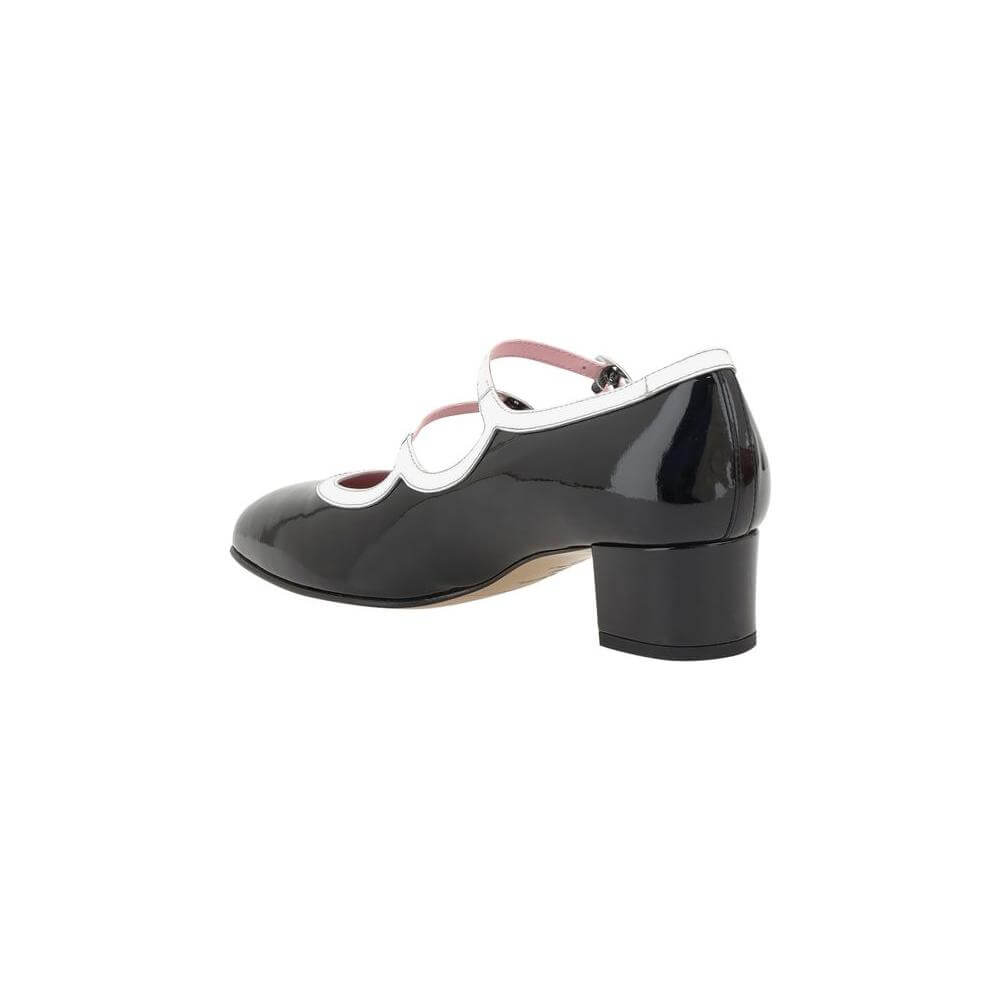 Black and white Carel Paris Kina Pumps with patent leather, almond toe, adjustable straps, and chunky heel for elegance and comfort.