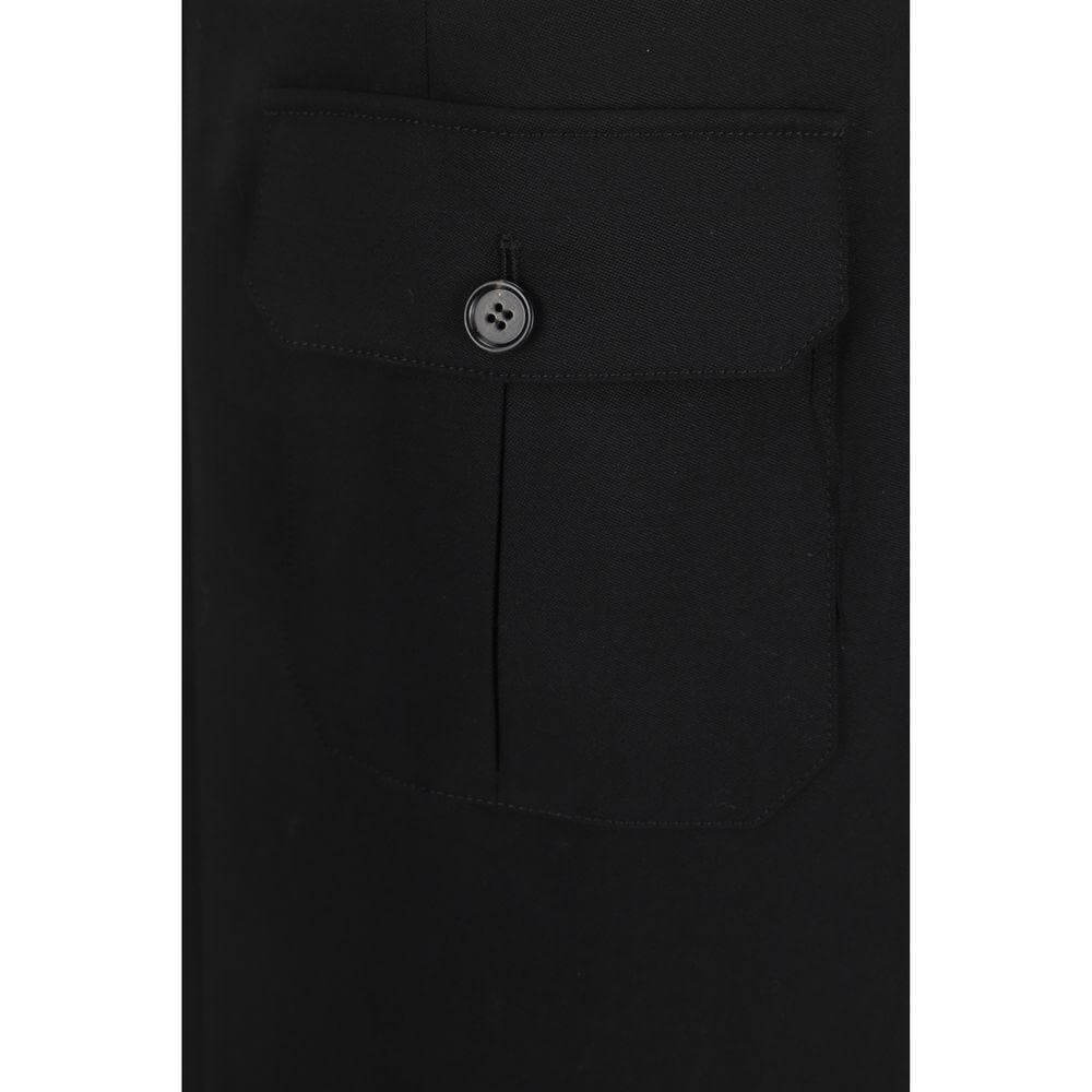 Close-up of Chloé black virgin wool midi skirt with front patch flap pocket and button detail.