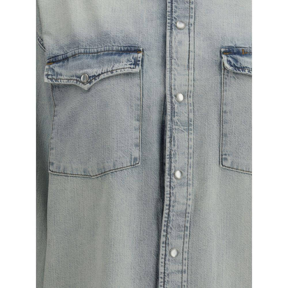 Close-up of RE/DONE denim shirt with classic collar, snap-button closure, and two flap pockets for a timeless, functional style.