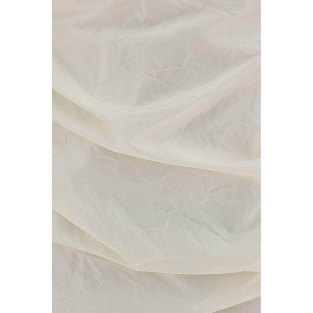Close-up of ruched silk fabric with a soft, crumpled texture in beige, showcases intricate detailing and elegance.