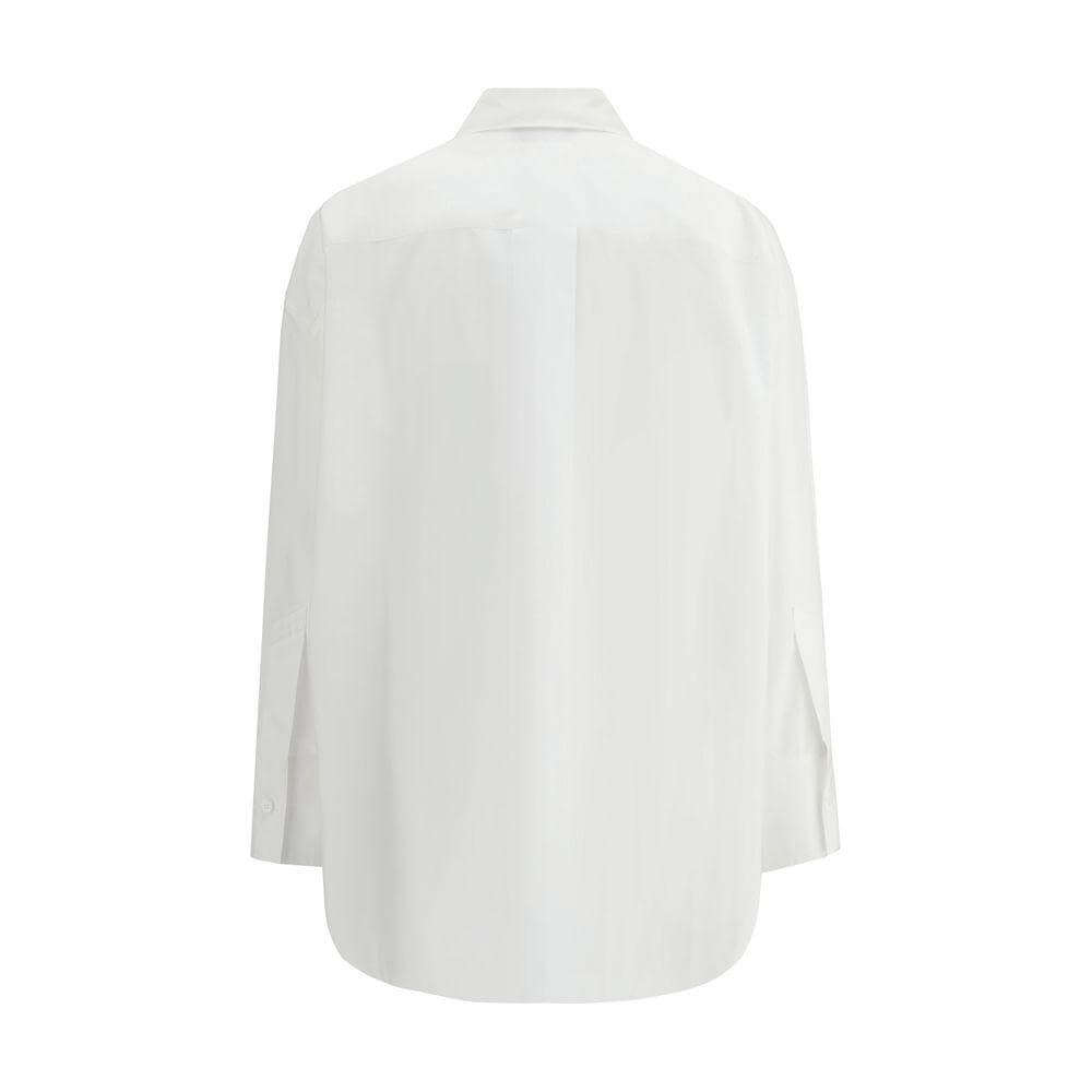 Back view of The Attico oversized cotton shirt with wide sleeves, featuring asymmetrical front slit and tone-on-tone logo.
