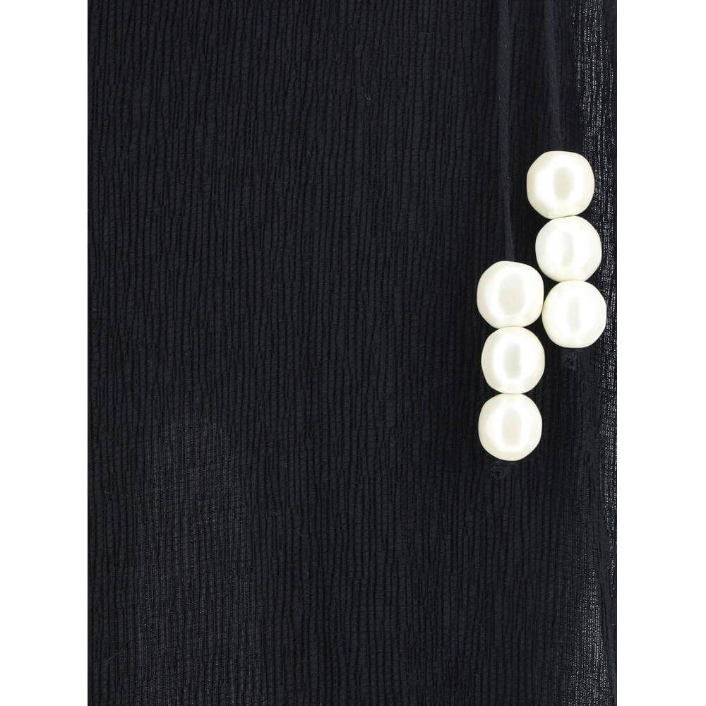 Magda Butrym pareo long skirt with knotted waist and XL pearl detail, showing monochrome pattern in a close-up view.