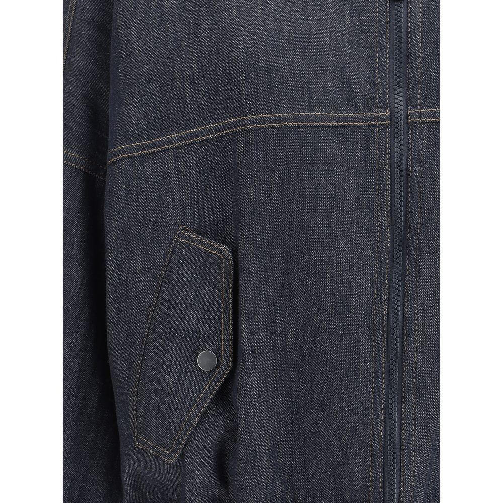 Brunello Cucinelli denim jacket close-up featuring stitching detail and side flap pocket with button.
