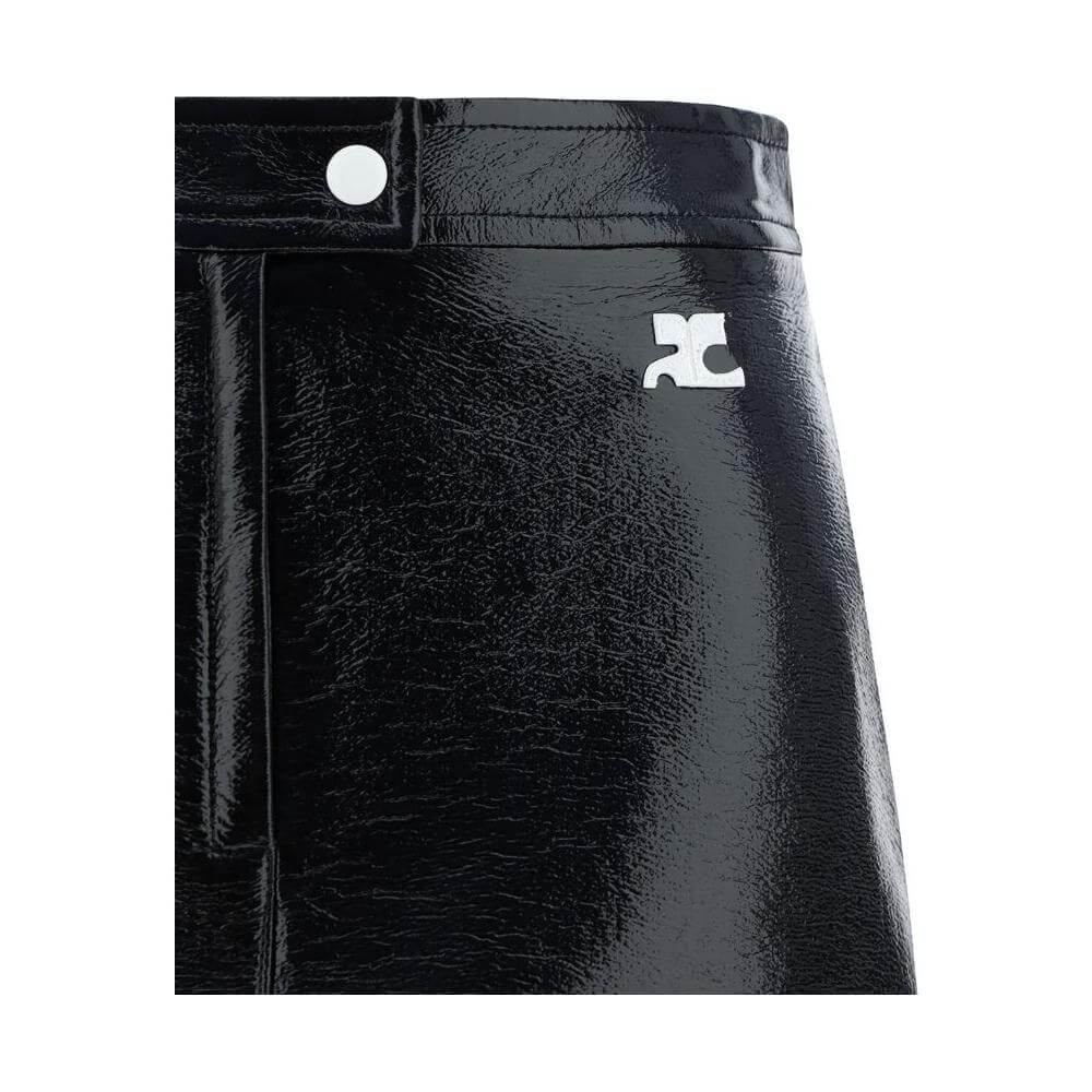 Courrèges black cotton mini skirt with coated fabric, button, zipper closure, and logo applique on front panel.