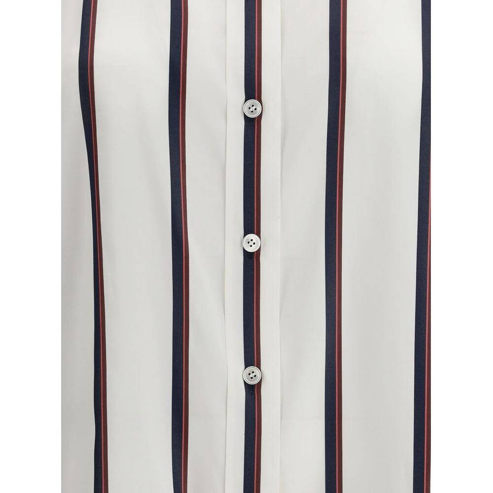 Close-up of Alexander McQueen silk striped shirt with button closure and elegant pattern.