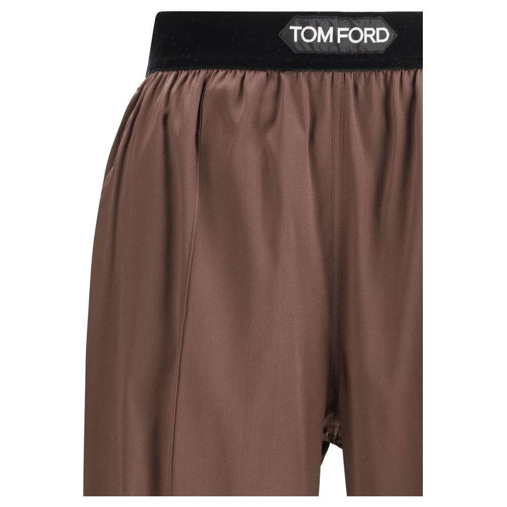 Tom Ford silk pants with contrasting elastic waistband and logo, featuring front pockets and back patch pockets.