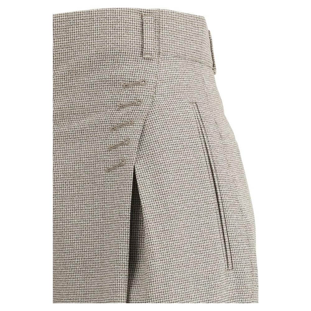 Close-up of Fendi pied-de-poule wool pants showing detailed stitching and side welt pocket for a sophisticated look.