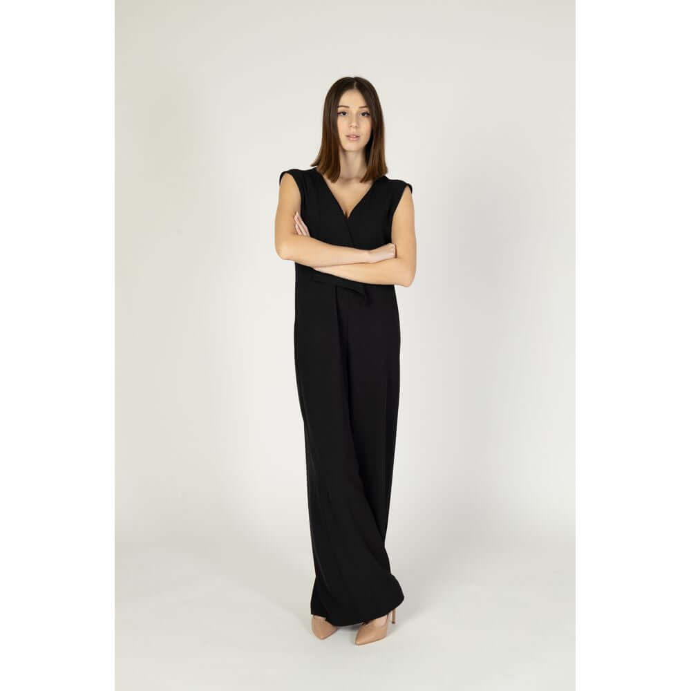 Woman wearing Sandro Ferrone black polyester jumpsuit, elegant spring/summer collection, composed of 96% polyester, 4% elastene.