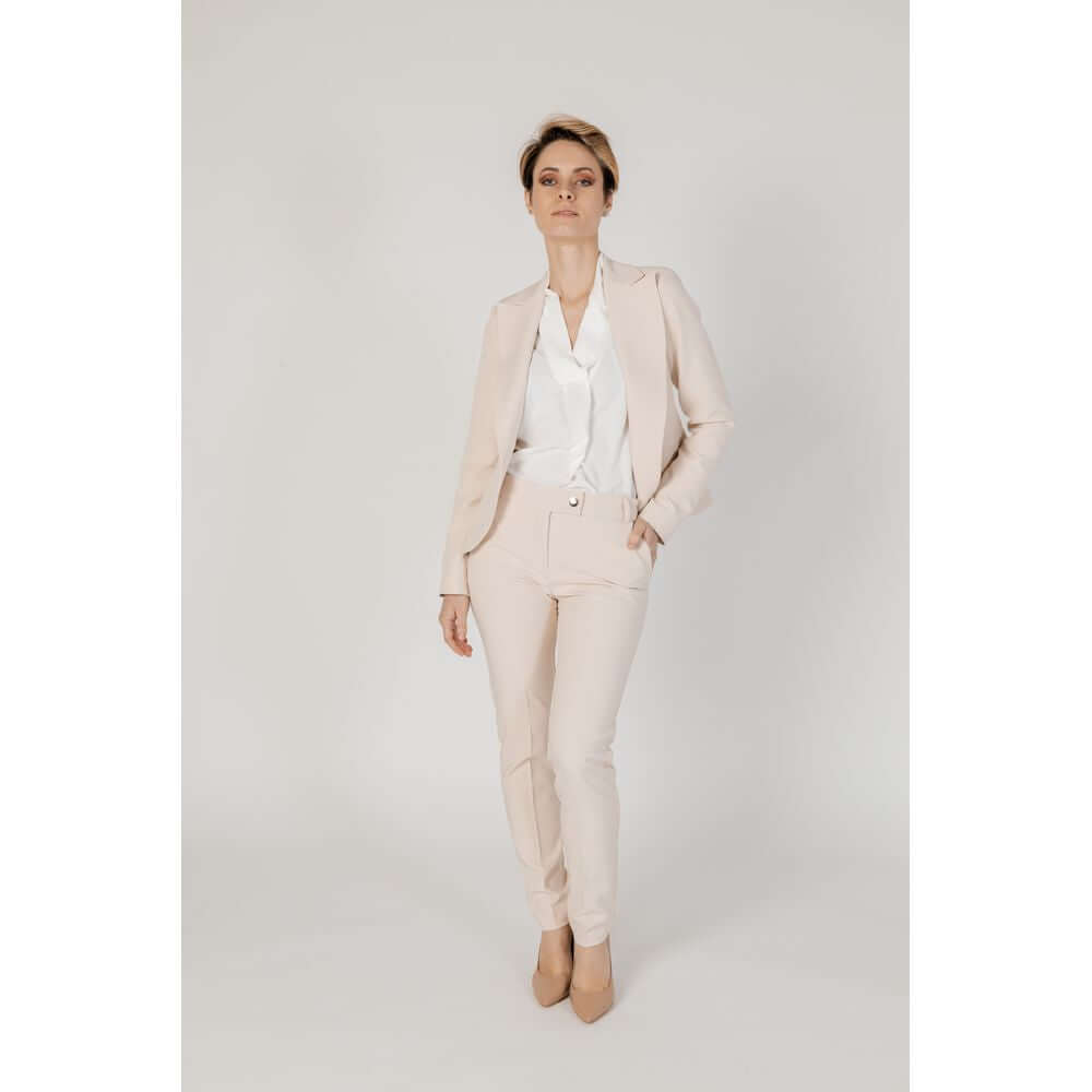 Woman wearing Rinascimento beige polyester suit and blazer from Spring/Summer collection, consisting of 90% polyester and 10% elastane.