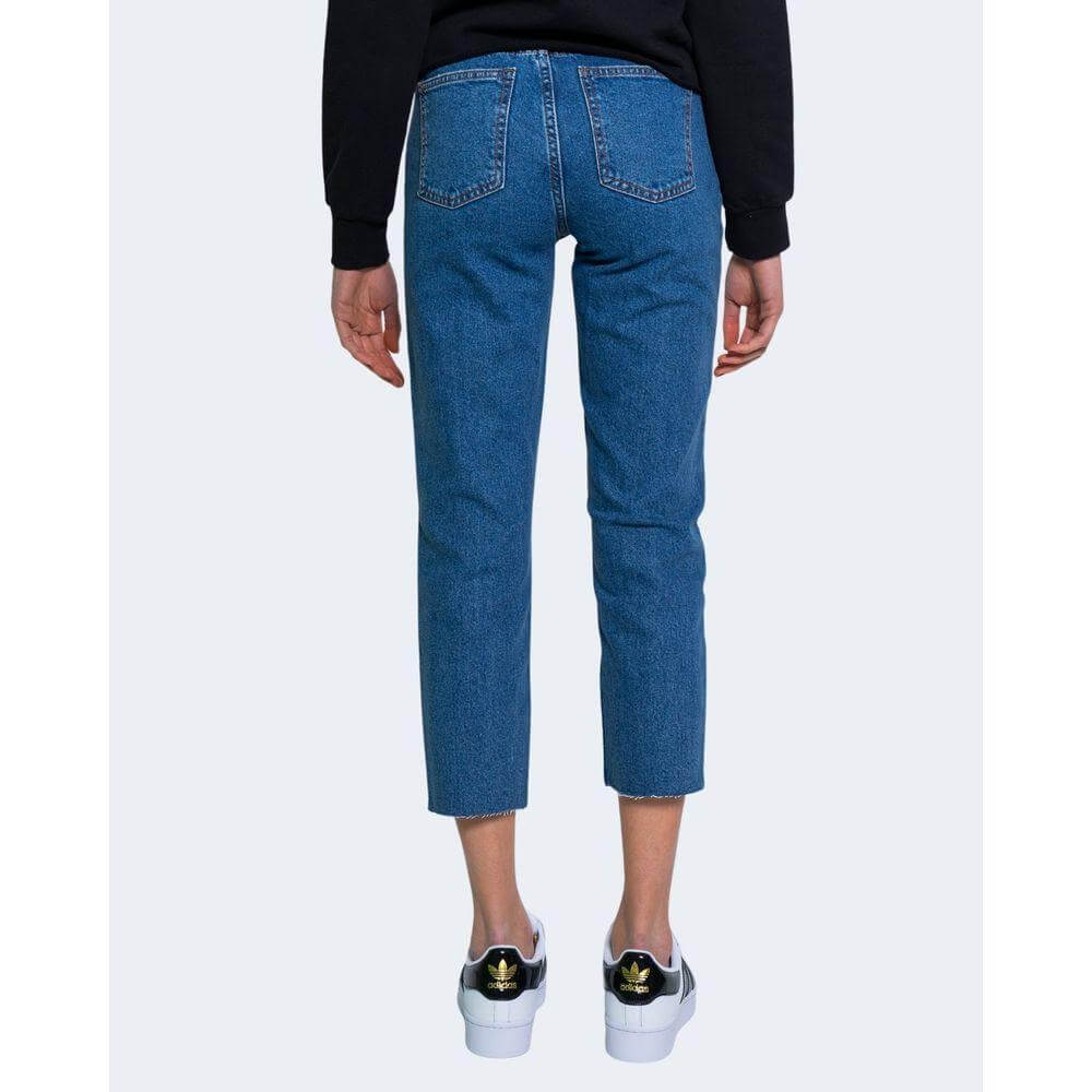 Woman wearing Only Blue Cotton Jeans with high waist and ankle-length cut, showcasing stylish back view with comfortable fit.