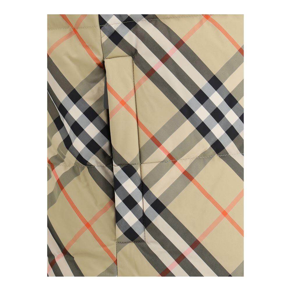 Close-up of Burberry reversible down vest showcasing the iconic check pattern with a side welt pocket.