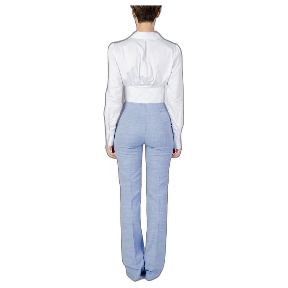 Back view of women's Guess white cotton long-sleeved shirt paired with blue pants, featuring 97% cotton and 3% elastane.
