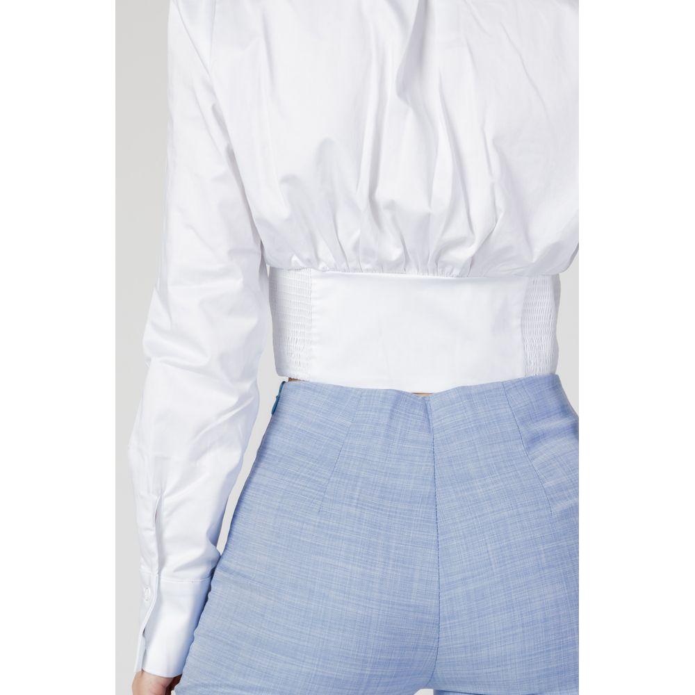 Back view of Guess women's long-sleeved white cotton shirt paired with high-waisted blue pants.
