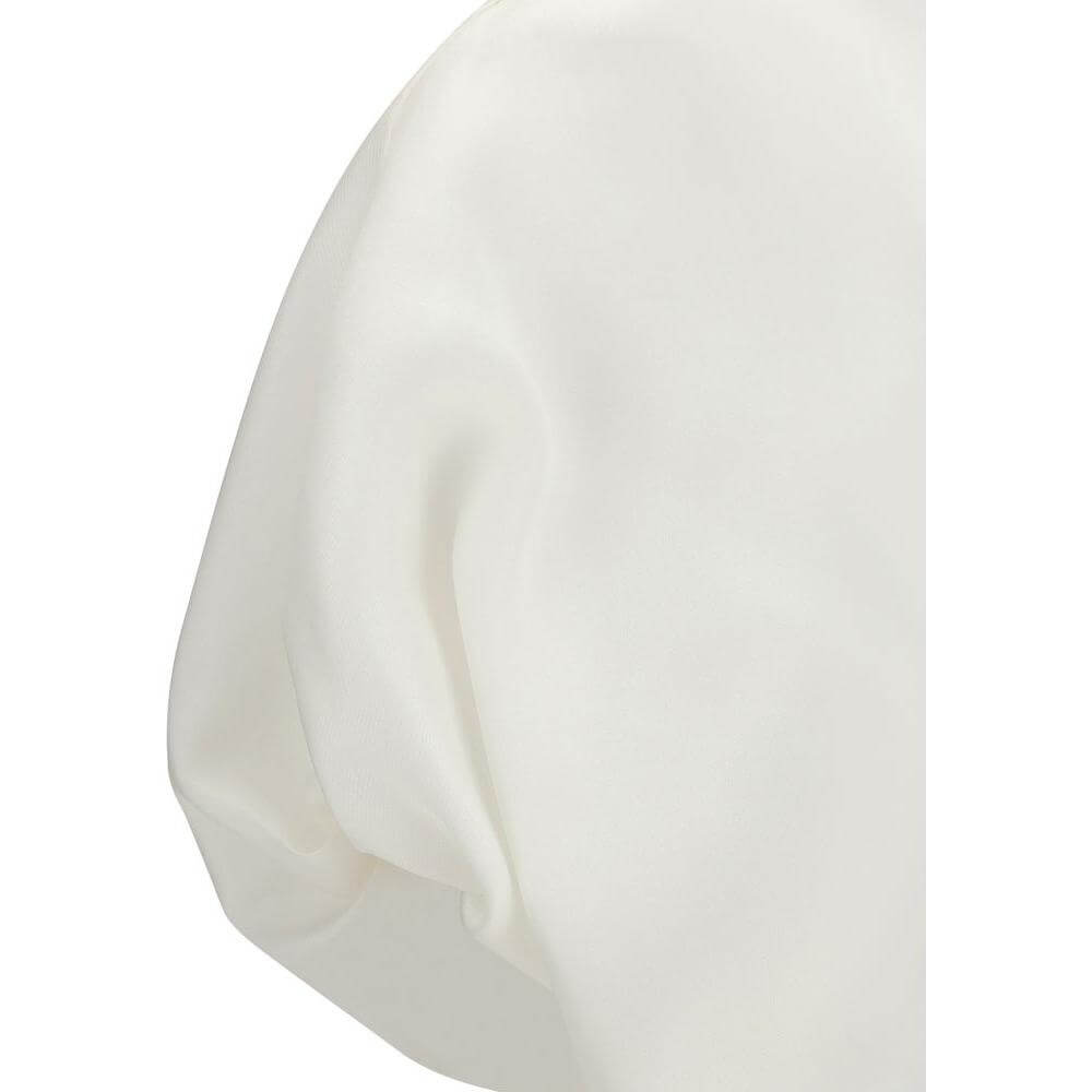 Close-up of Khaite Niles Silk Top showing pleat detail and soft silhouette in a monochrome pattern.