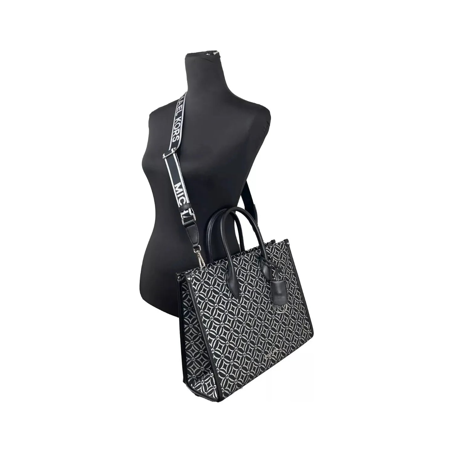Michael Kors Mirella medium top zip crossbody tote bag in black leather with adjustable strap on mannequin.