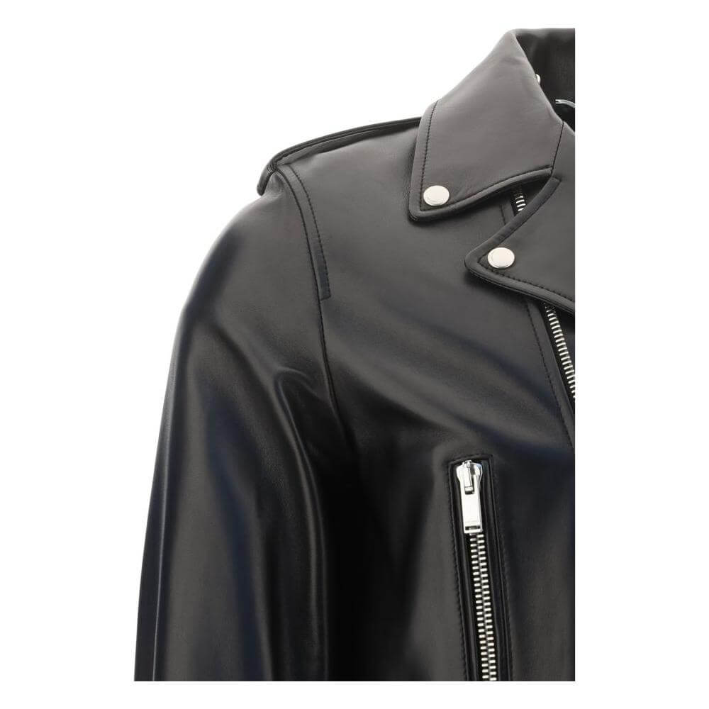 Close-up of Saint Laurent lambskin leather jacket with buttoned lapel and asymmetrical zipper, showcasing sleek metal details.
