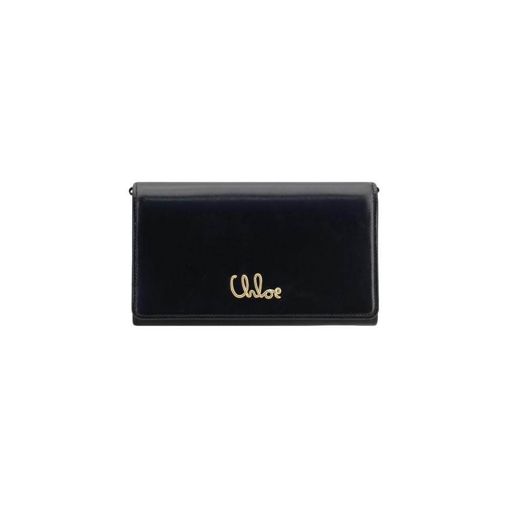 Chloé Iconic Pochette in black with gold logo, featuring a magnetic flap and removable chain, perfect for versatile styling.