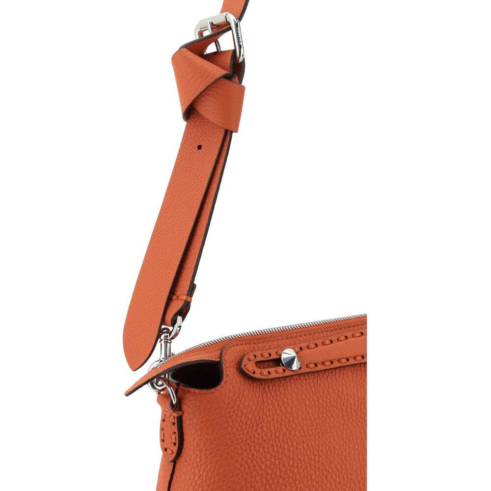 Close-up of Fendi By The Way Selleria Medium Shoulder Bag in orange leather with adjustable strap and zipper detail.