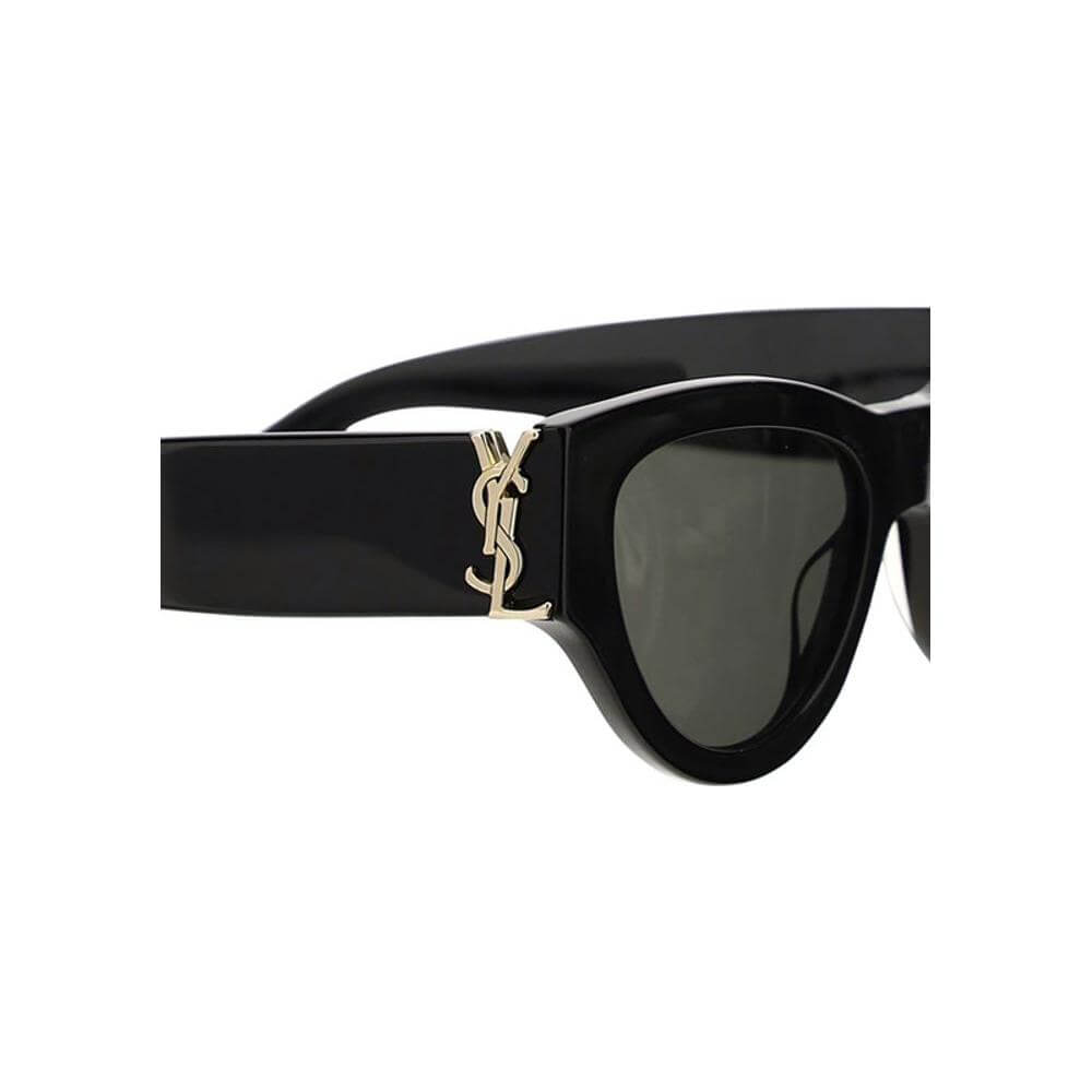 Close-up of Saint Laurent Cat-eye Sunglasses with black frames and gold logo on the side, exuding vintage glamour and contemporary style.