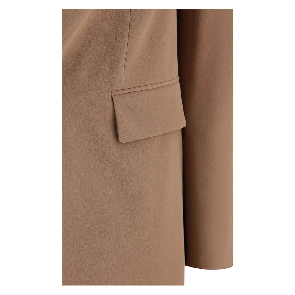 Close-up of Saint Laurent single-breasted blazer showing welt flap pocket and elegant minimalist design.