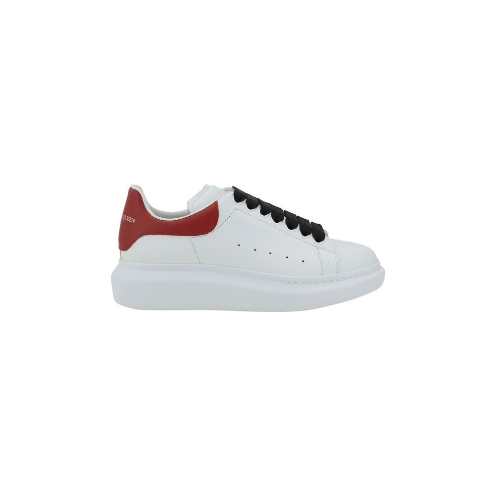 White leather sneaker with red heel and black laces by Alexander McQueen, featuring a platform sole and logoed details.