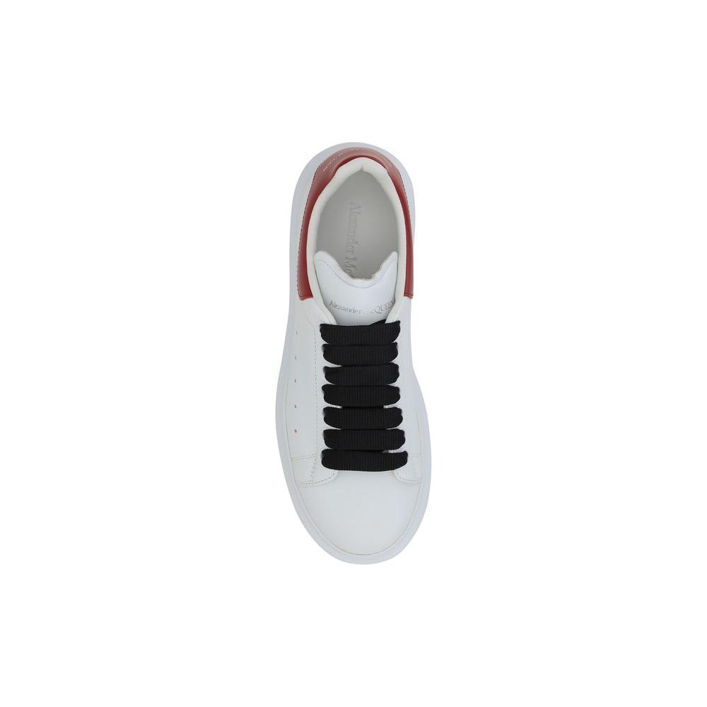 Top view of Alexander McQueen white leather sneaker with black laces and red heel, showcasing contemporary design and iconic branding.