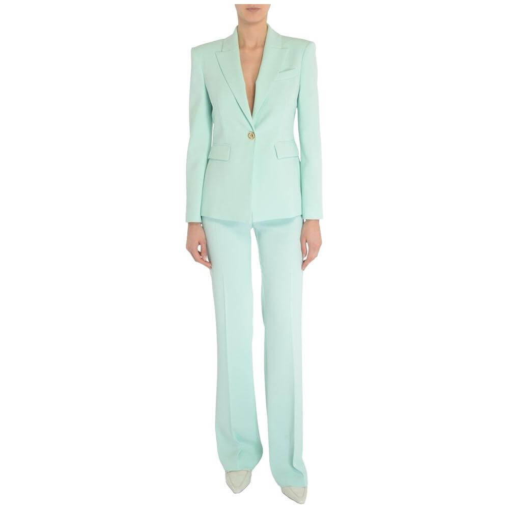 Woman in light blue PINKO pant suit; elegant style.