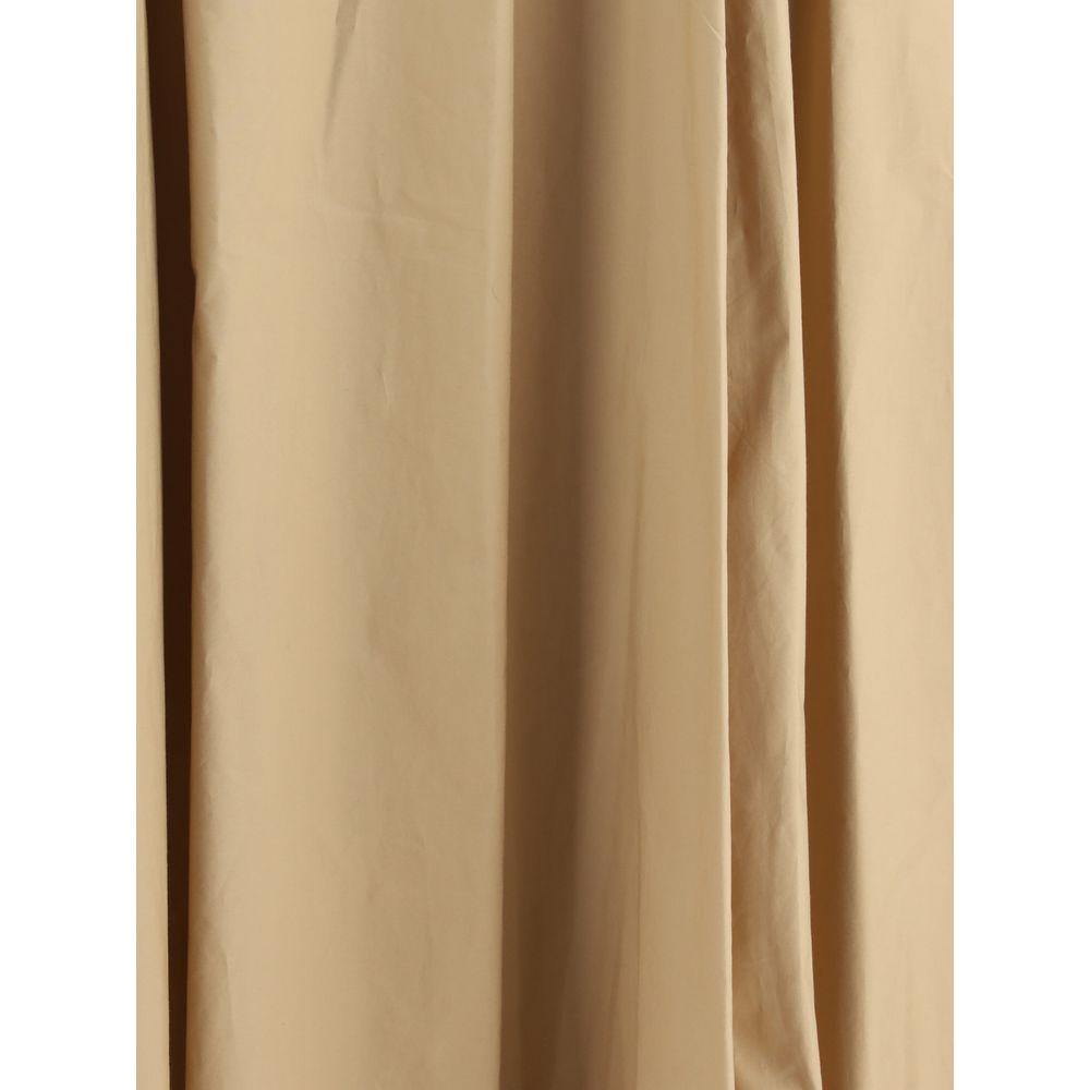 Close-up of beige cotton Amphora Skirt fabric, showing pleated design and soft texture for elegant and sophisticated look.
