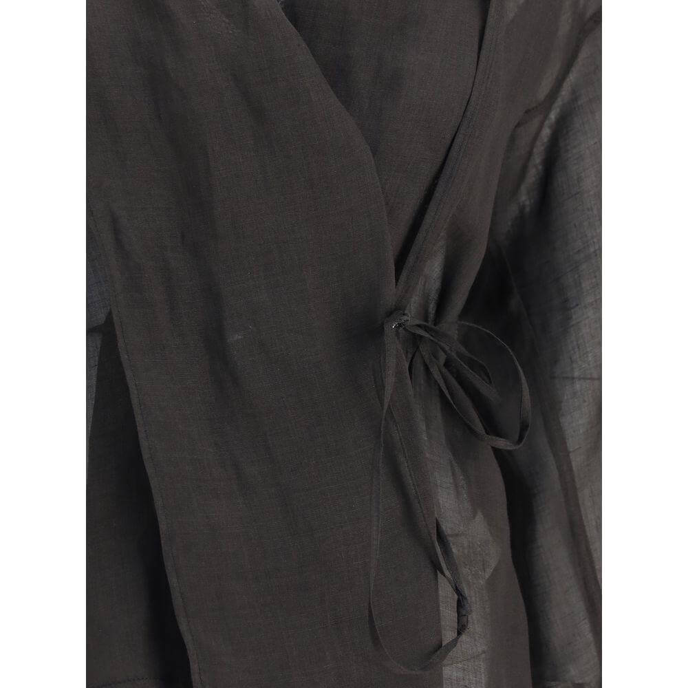 Forte_Forte Crossed shirt close-up with shawl lapels, knotted ribbon closure, and semi-transparent fabric for a modern, airy style.