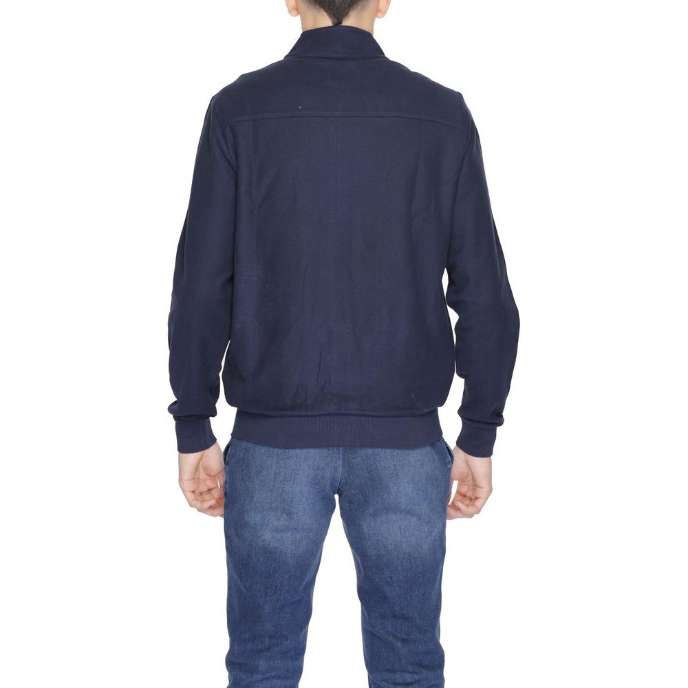 Back view of a man wearing a U.S. Polo Assn. blue cotton jacket with a high collar, ideal for stylish and comfortable spring attire.