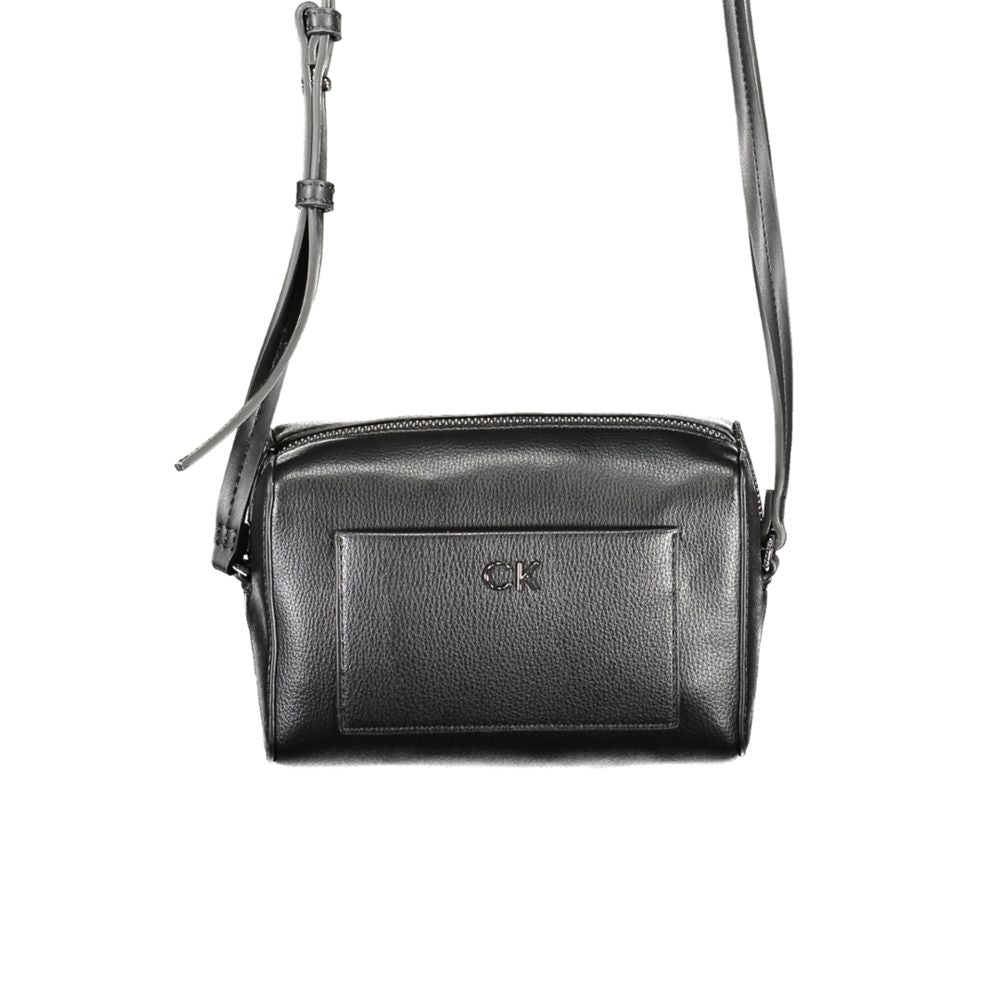 Calvin Klein black polyester handbag with adjustable shoulder strap, external and internal pockets, and zip closure.