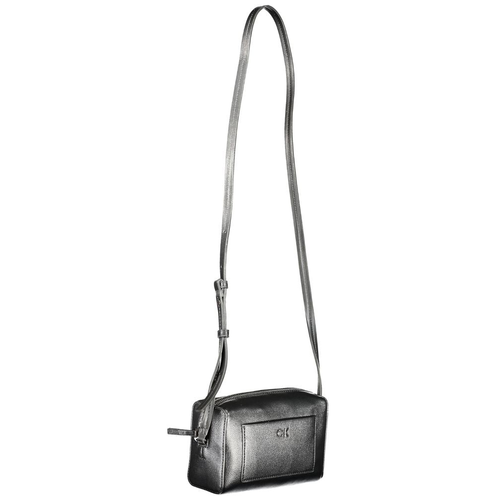 Calvin Klein black polyester handbag with adjustable shoulder strap, external pocket, internal card pocket, and zip closure
