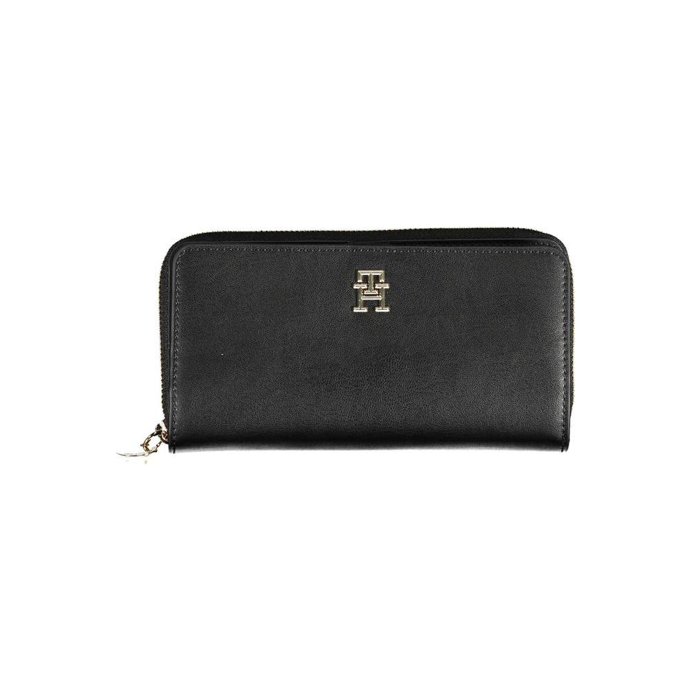 Tommy Hilfiger black polyethylene women wallet with logo, featuring double compartments and zip closure for a sleek, elegant look.