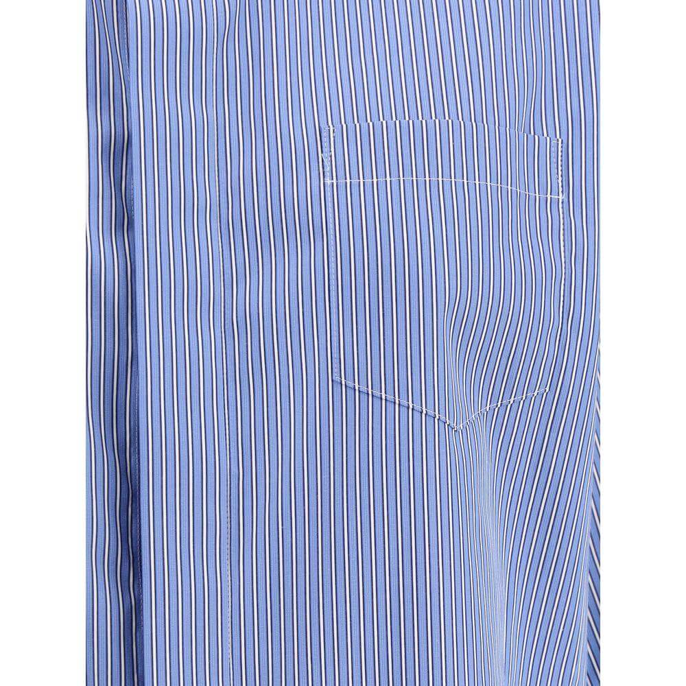 Close-up of Sacai three-quarter sleeve shirt with blue and white stripes, showing the breast pocket and detailed stitching.