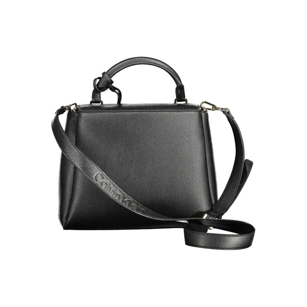Calvin Klein black polyester women's handbag with adjustable shoulder strap, featuring dual compartments and exterior pocket for easy access.