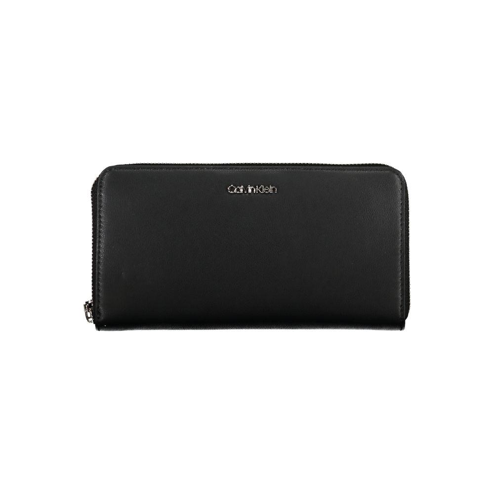 Calvin Klein black polyethylene wallet with zip closure, 5 compartments, coin purse, card slots, and removable pull, featuring logo.