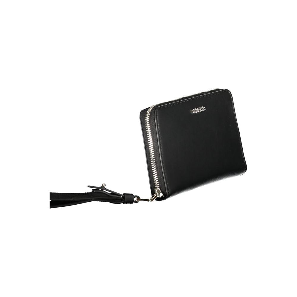 Calvin Klein black polyethylene wallet with zip closure, logo, and removable pull; features 5 compartments and coin purse.