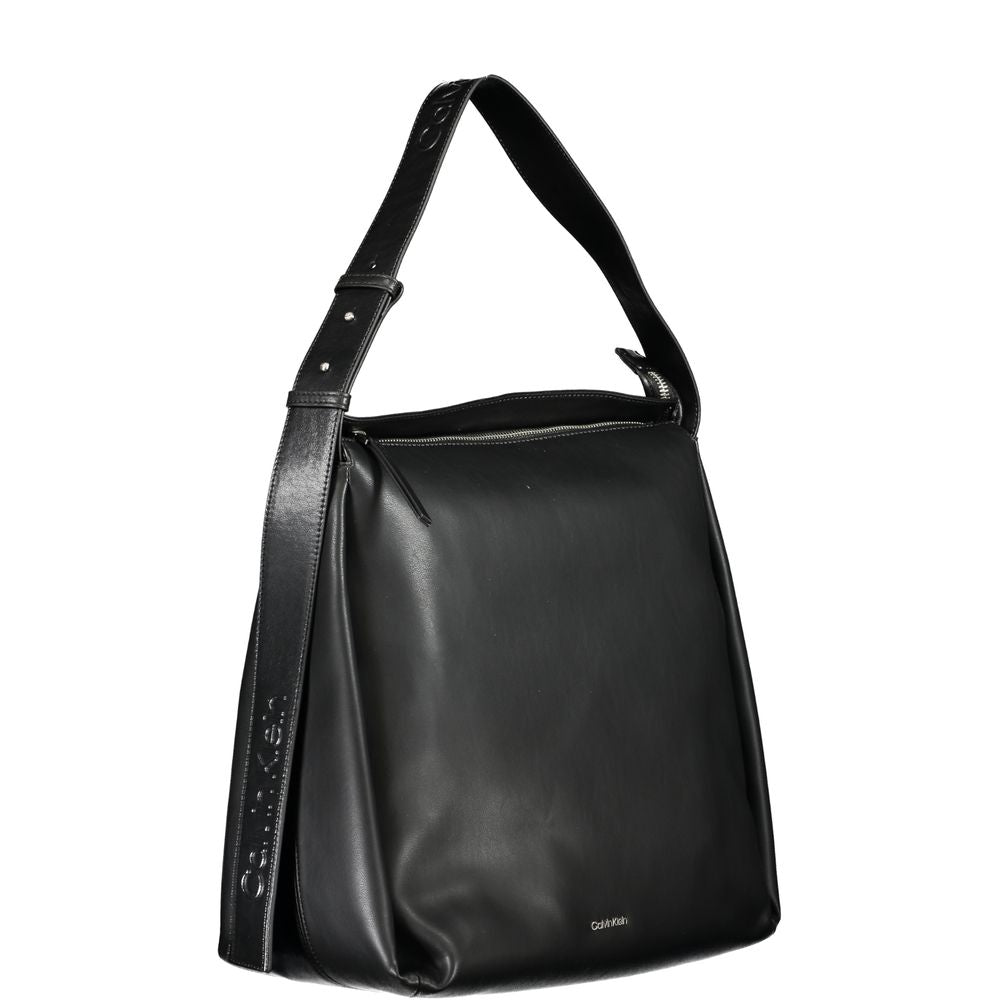 Calvin Klein black polyester handbag with adjustable shoulder handle, zip closure, internal pocket, featuring brand logo, eco-friendly material.