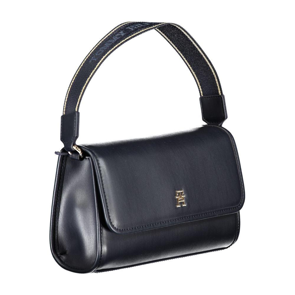 Tommy Hilfiger blue handbag with shoulder handle, internal pocket, and snap closure, featuring logo on the front.