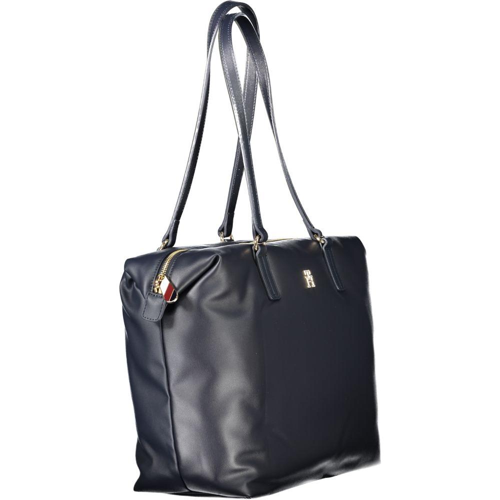 Tommy Hilfiger blue polyester women’s shoulder bag with twin handles and zip closure, featuring the iconic Tommy logo.