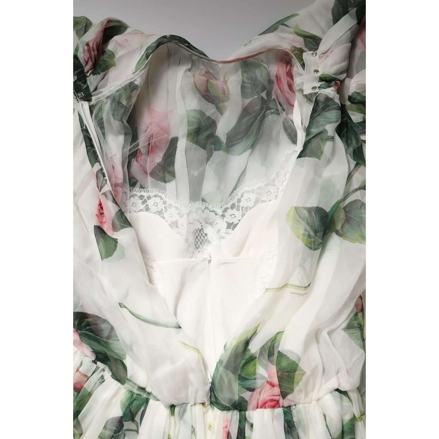 Dolce & Gabbana white maxi dress with pink rose print, featuring lace detail and silk material, close-up view.