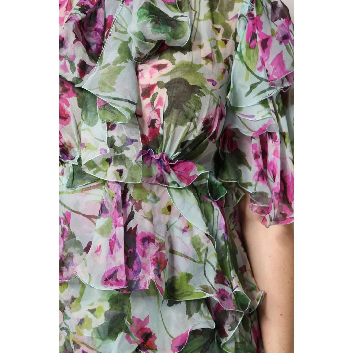 Close-up of Dolce & Gabbana multicolor floral silk midi dress showcasing layered ruffles and vibrant floral pattern.