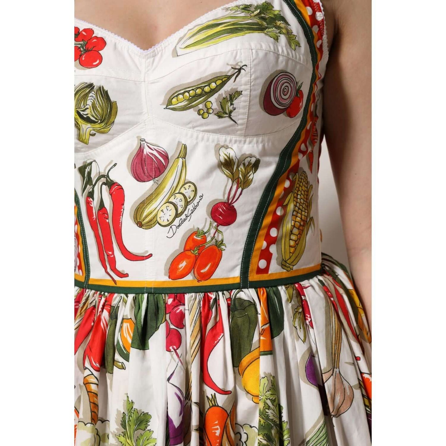 Dolce & Gabbana white sleeveless A-line dress with colorful vegetable print, cotton material and zipper closure.