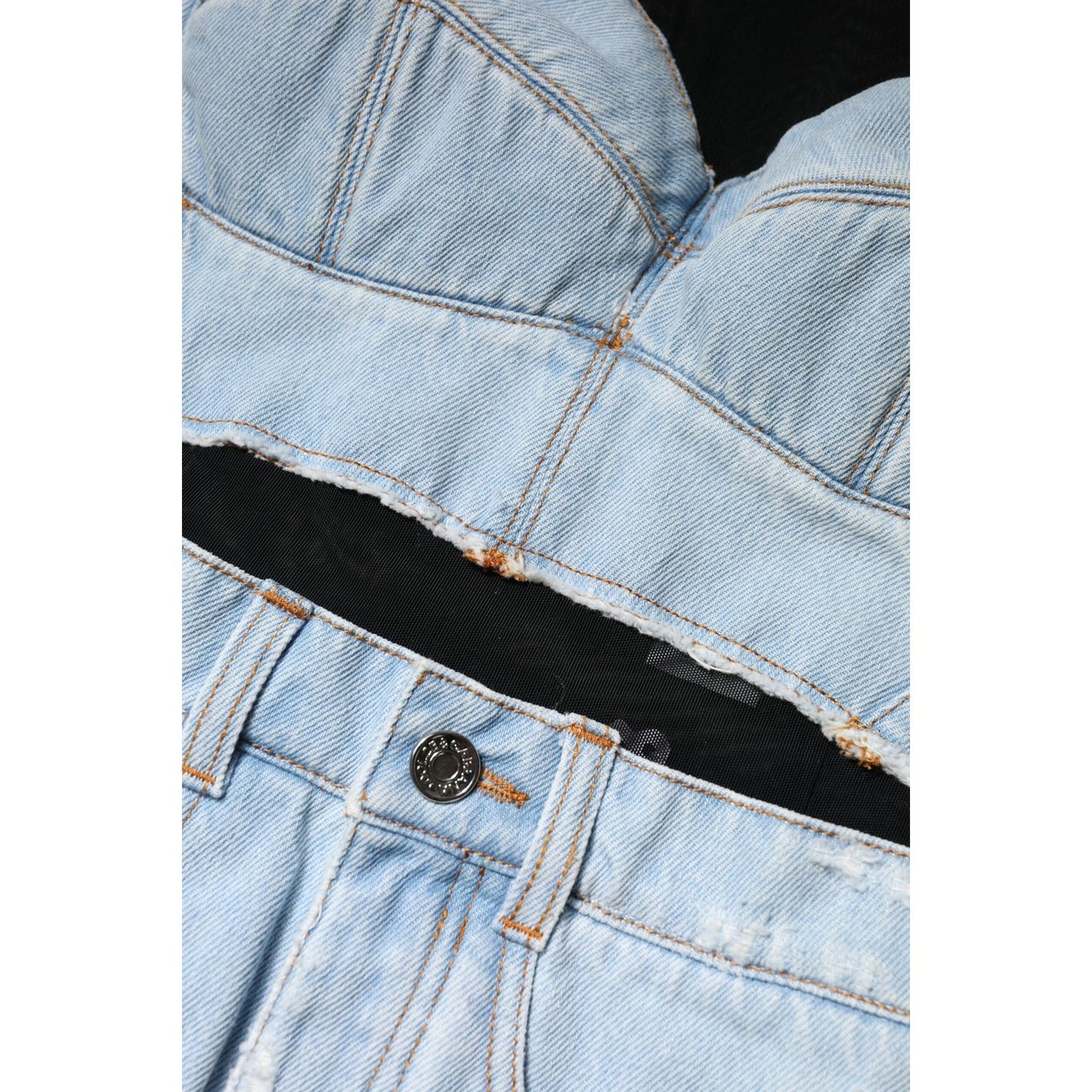 Close-up of Dolce & Gabbana blue denim mini dress with black lining and button, showcasing high-quality stitching and zipper details.