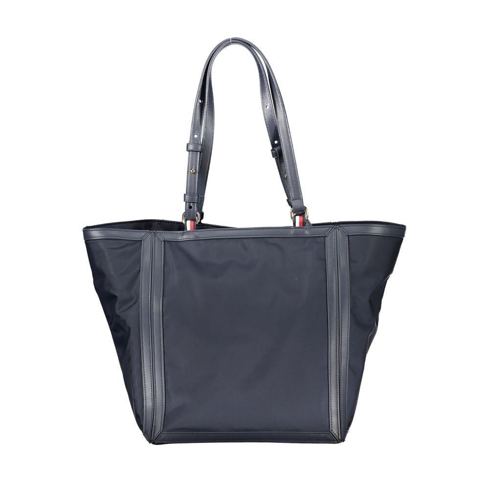 Tommy Hilfiger blue polyester handbag with adjustable shoulder handles, zip closure, and logo detailing, made from recycled materials.