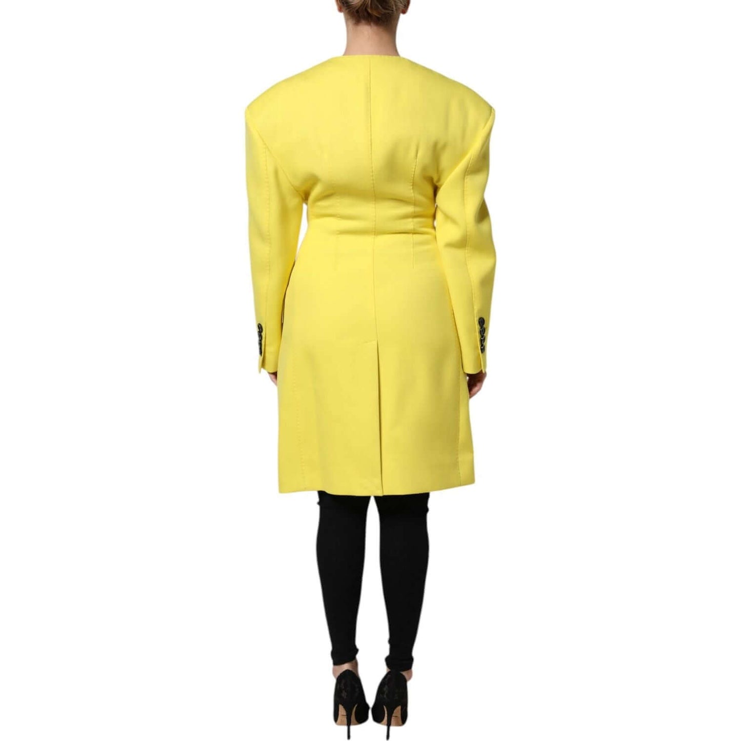Back view of a Dolce & Gabbana yellow double breasted trench coat jacket, 100% virgin wool, regular fit, with button closure detail.