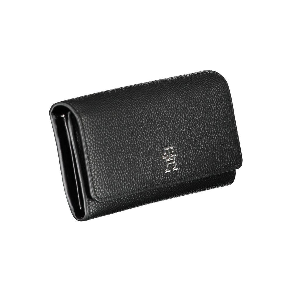 Tommy Hilfiger black polyethylene women's wallet with iconic logo, featuring spacious compartments and secure snap closure for modern style.