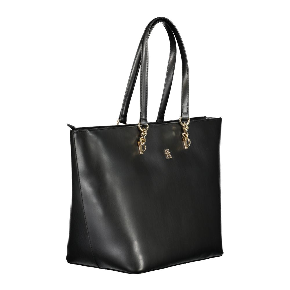 Tommy Hilfiger black polyethylene handbag with dual shoulder handles, zip closure, logo detailing, and two internal pockets.
