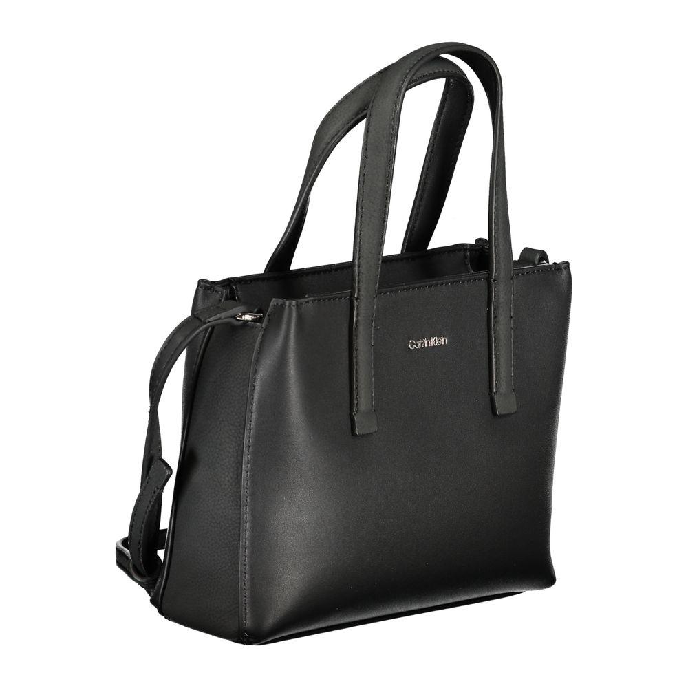 Calvin Klein black polyester handbag with two handles, shoulder strap, card pocket, and zip closure.