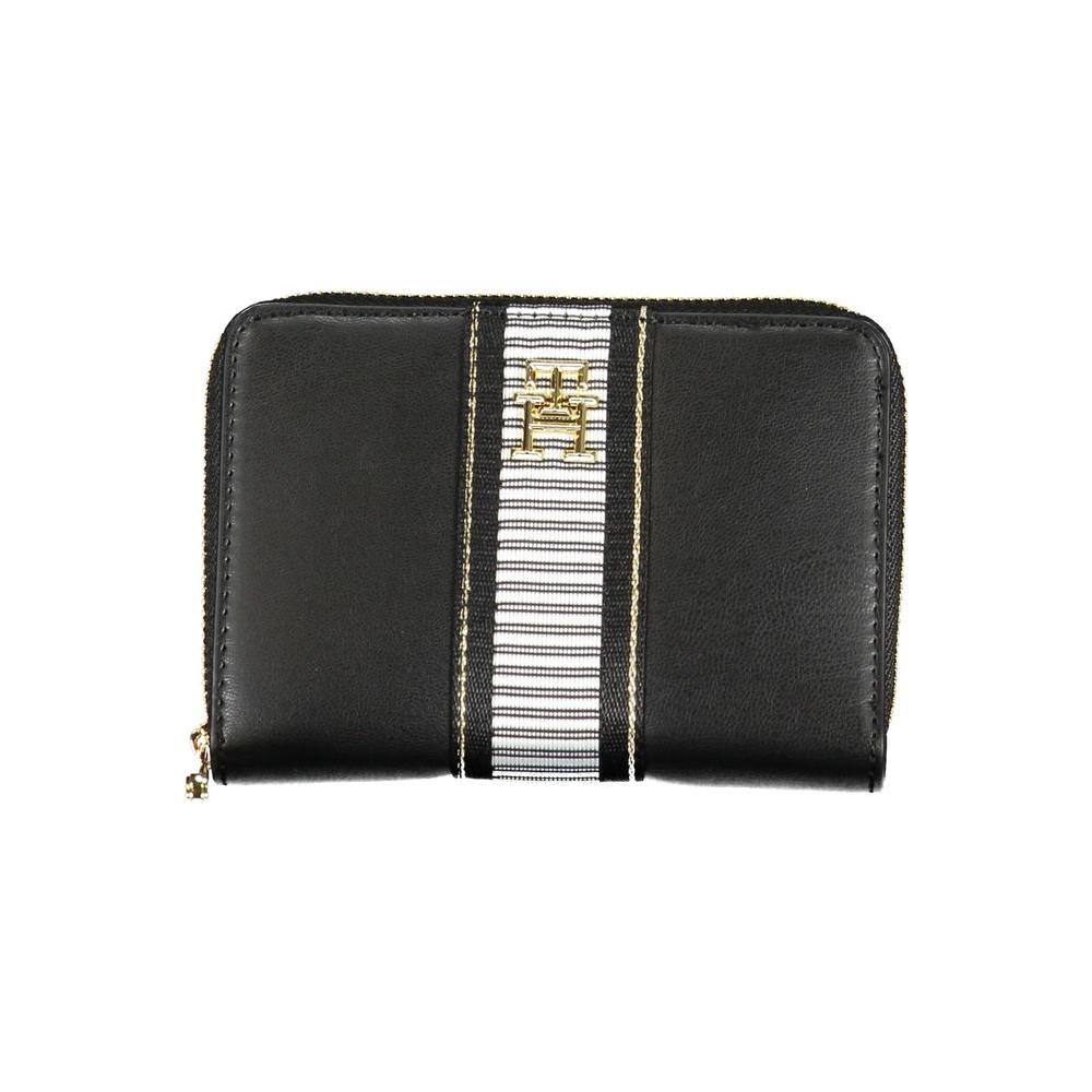 Tommy Hilfiger black polyethylene wallet with contrasting details, zip closure, and logo; features multiple compartments and coin purse.